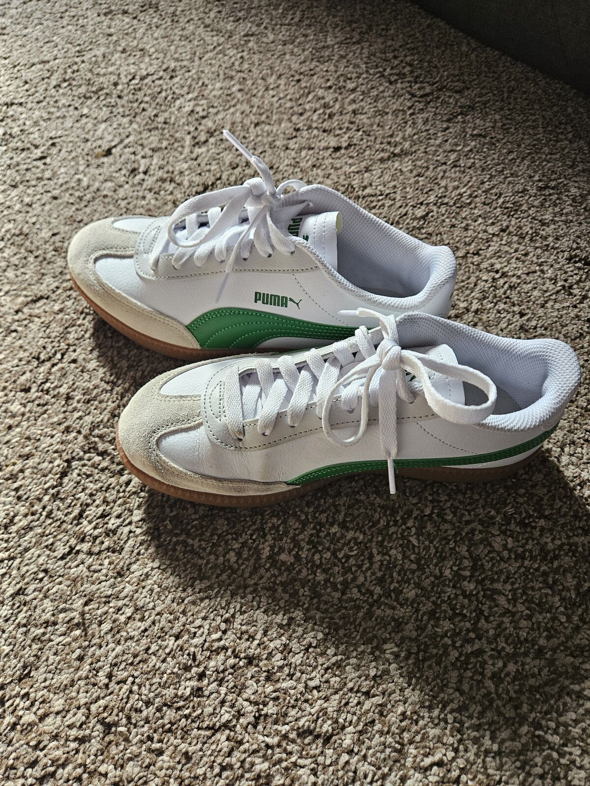 Green and white womens pumas