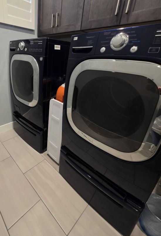 LG Front Load Washer and Electric Dryer with pedestals