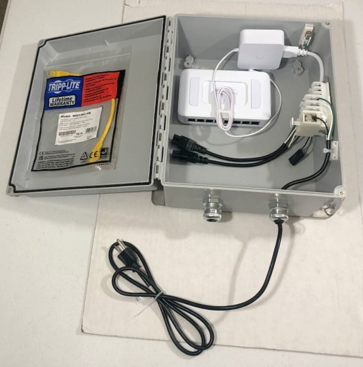 USW-LITE-8-POE UniFi Ethernet Switch 8-Ports w/ adaptor contained in a Hoffman A12106CHQRFG NEMA 4x Enclosure Solid Cover