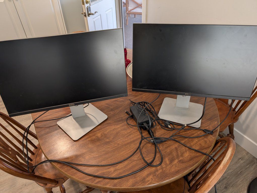 Two Dell U2414hb 24 in monitors, plus rotating and swiveling stands and docking station. 