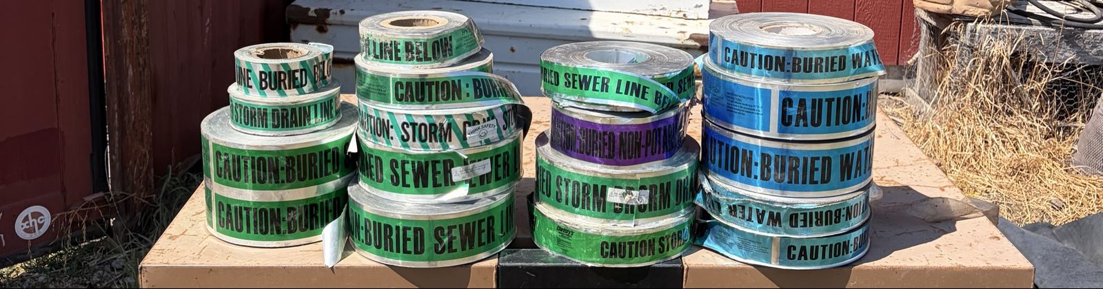 Buried waterline/sewer caution, tape