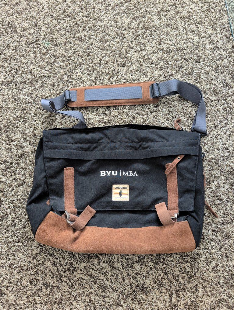 Cotopaxi Kpong 15L Satchel in black canvas with brown suede trim with BYU insignia