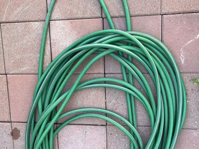 Green 100’ Outdoor Garden Water Hose.