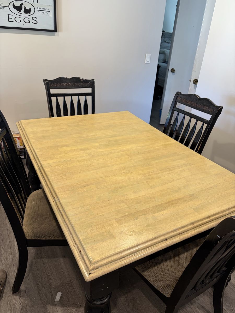 Black and Natural Wood Dining Table with 4 or 6 Chairs.  It does have an extension leaf. 