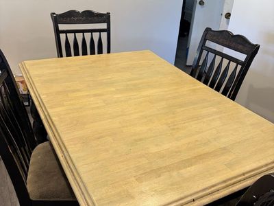 Black and Natural Wood Dining Table with 4 or 6 Chairs. It does have an extension leaf.