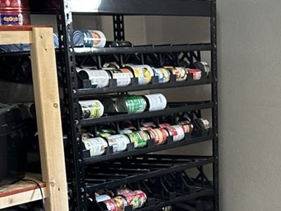 Two Black Shelf Reliance can rotation storage racks