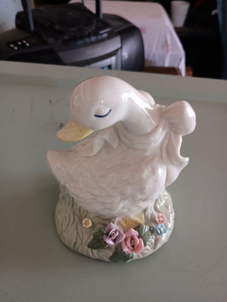 Vintage Ceramic Duck Figurine with Floral Base and Ribbon Accent