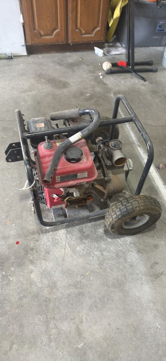 Red Gas-Powered Water Pump on Wheels - Industrial Equipment