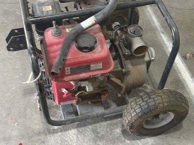 Red Gas-Powered Water Pump on Wheels - Industrial Equipment