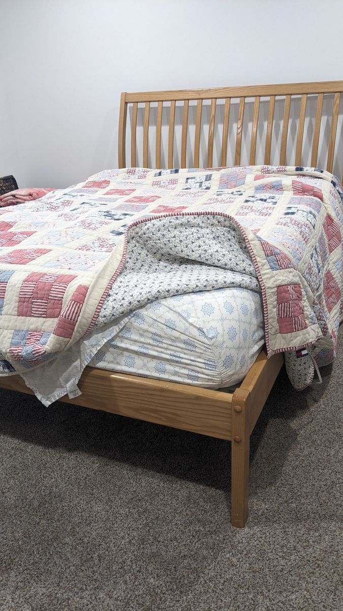 solid wood full size bed and purple mattress