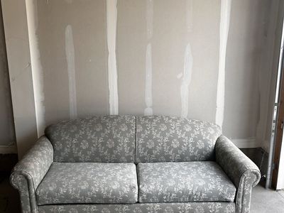 Sage green Floral Pattern Fabric loveseat with built in sleeper