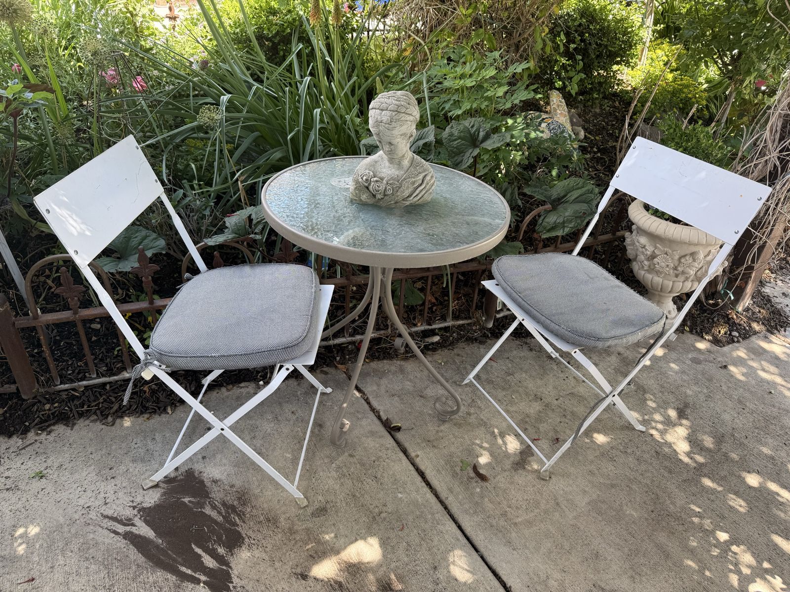 Smallish bistro set chairs all metal fold up for storage- statue in NOT for sale.