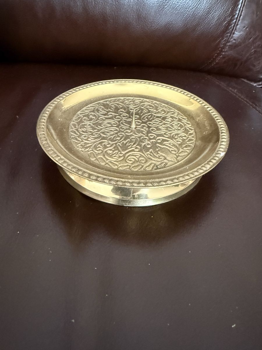 Brass intricate design candle holder stand a little over 5” wide by 1” tall