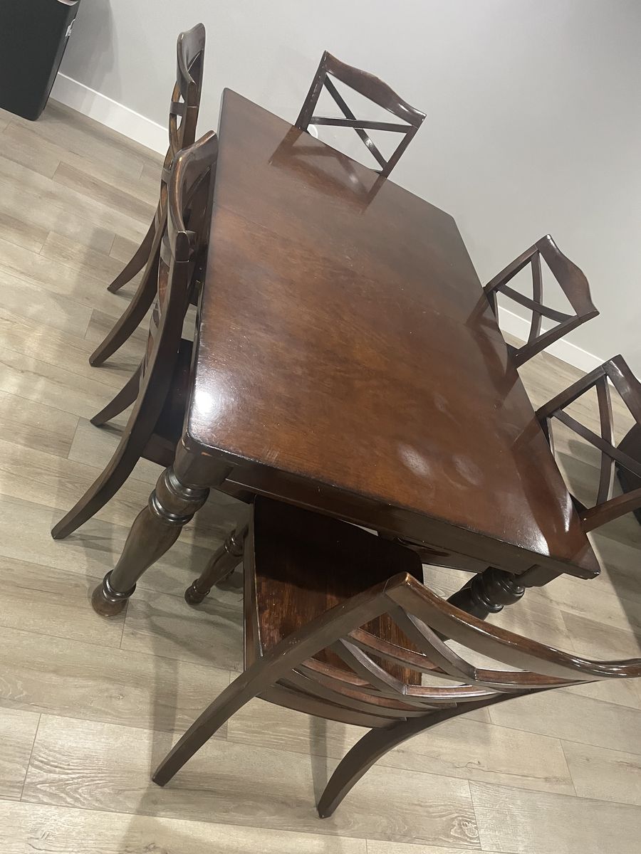 Dark brown, hard-wood table with extra leaf, and 6 chairs