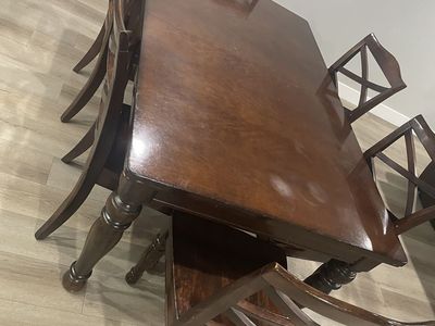 Dark brown, hard-wood table with extra leaf, and 6 chairs
