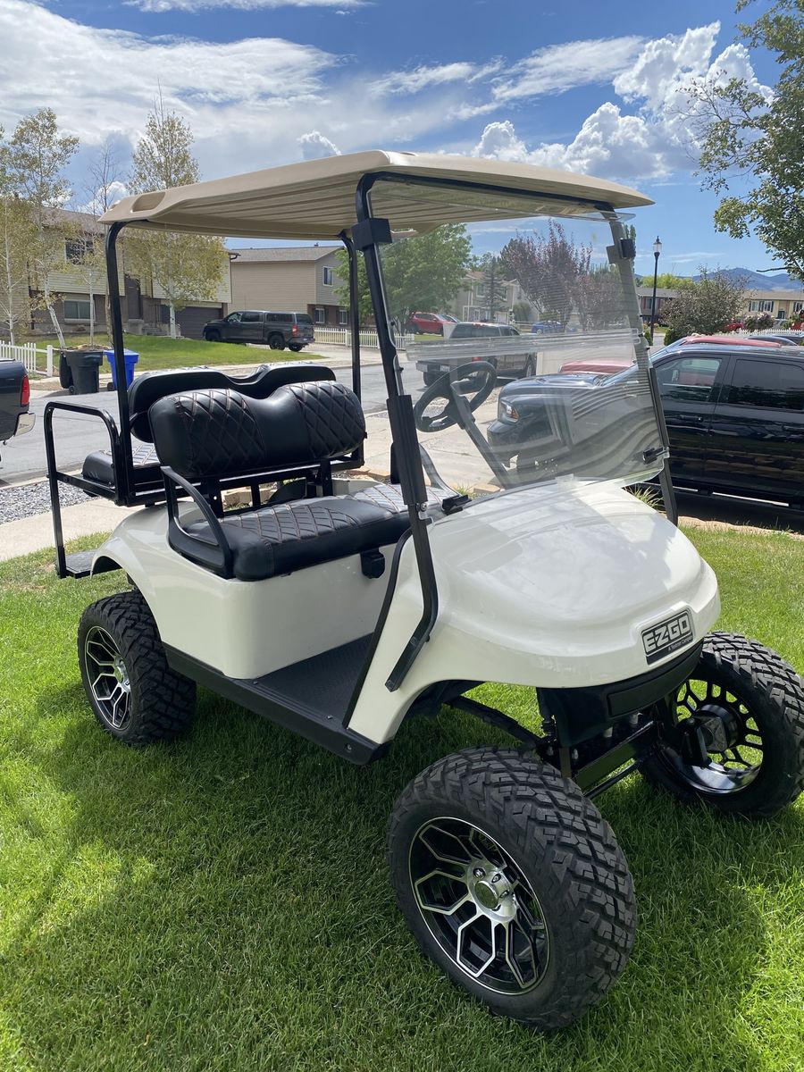 EZGO White Lifted Golf Cart with Custom Wheels & Rear Flip Seat