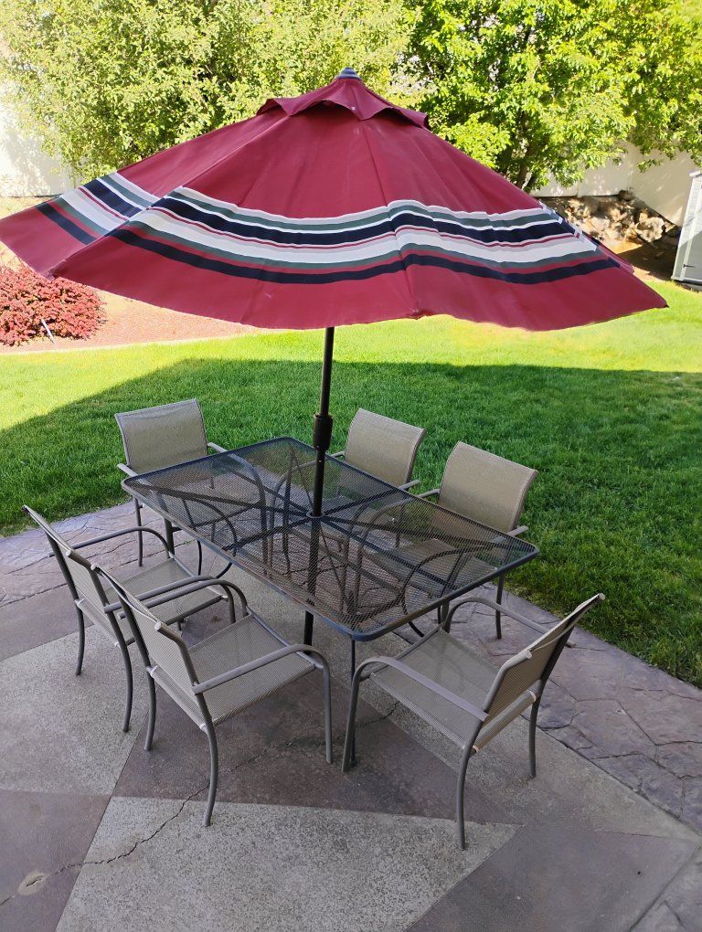 Patio table with chairs and umbrella