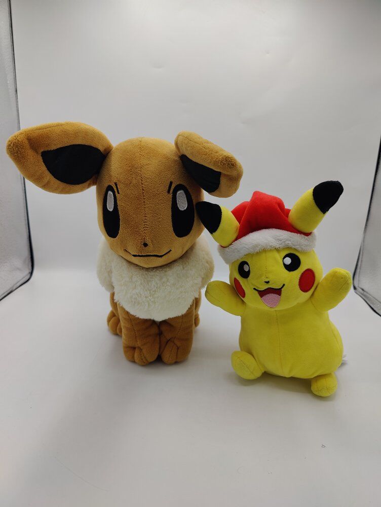 Pokemon Eevee and Santa Pikachu stuffed animals
