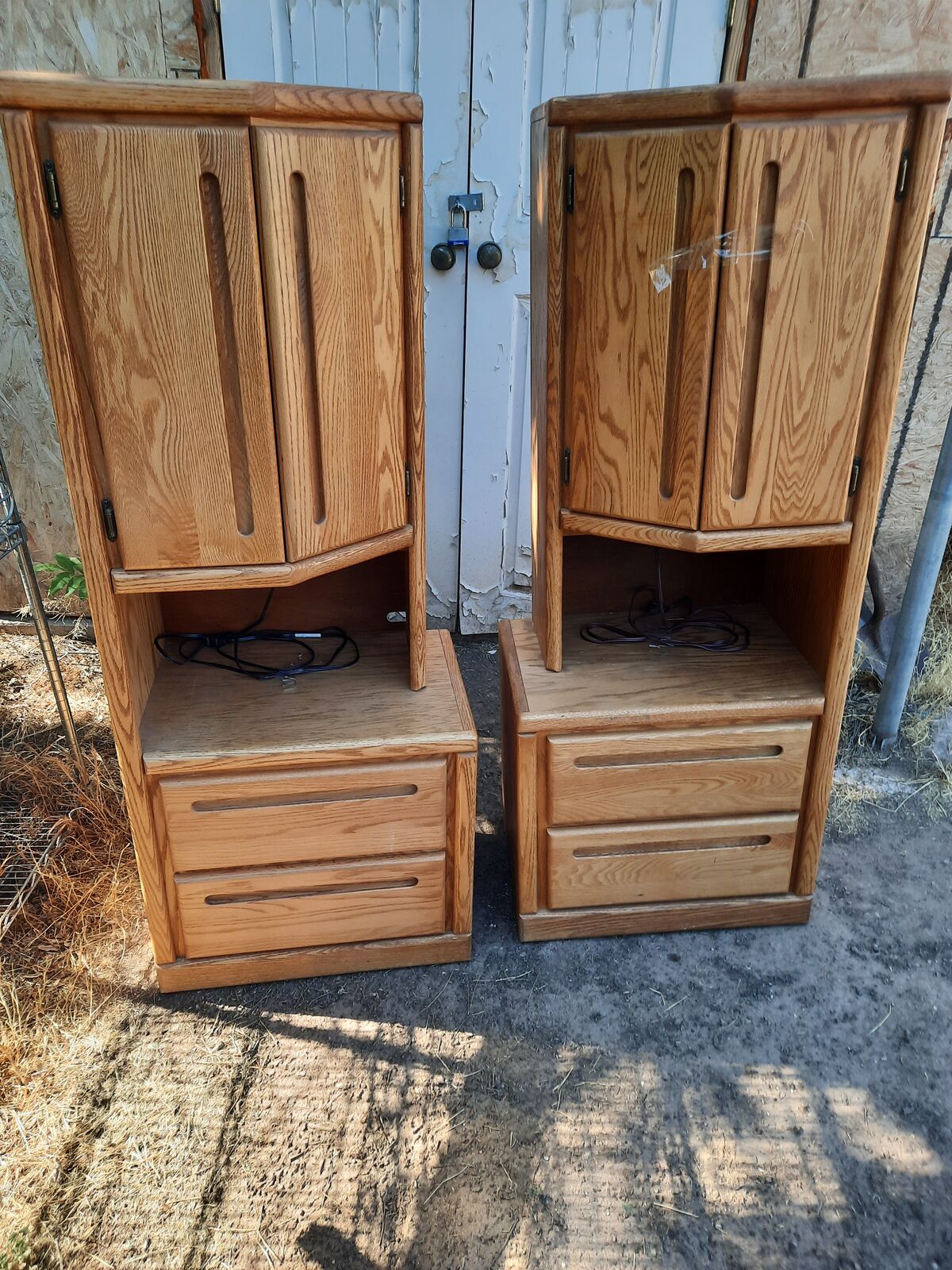 two tall matching nightstands with light