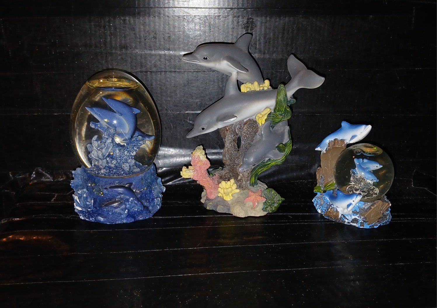 1 dolphin water globe and 2 dolphin figurines