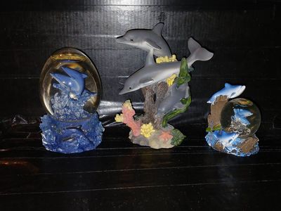 1 dolphin water globe and 2 dolphin figurines