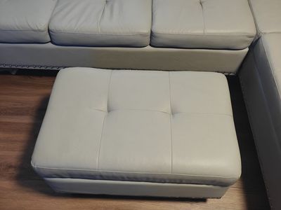 L-Shaped grey faux leather couch with ottoman