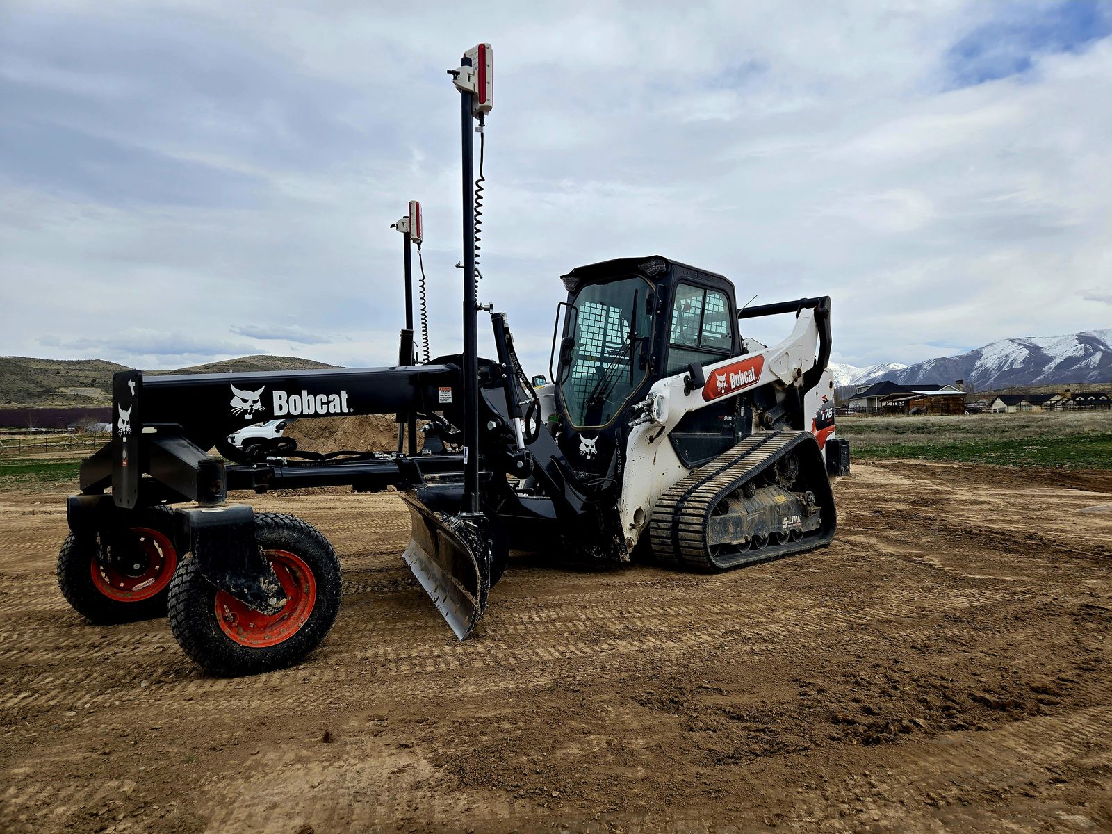 Bobcat T76 tracked skid steer with grader attachment