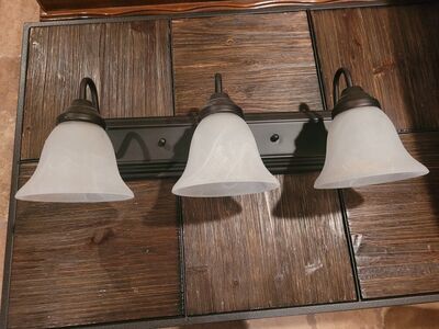 Three light Antique Bronze bathroom fixture.