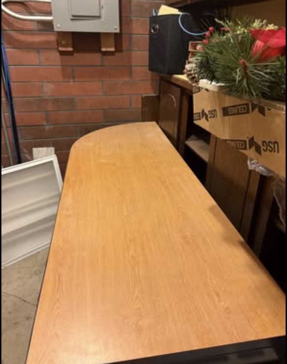 Office desk with attached 4-drawer filing cabinet.