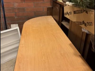 Office desk with attached 4-drawer filing cabinet.