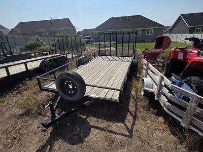2021 7'x14' single axle utility trailer with spare tire.