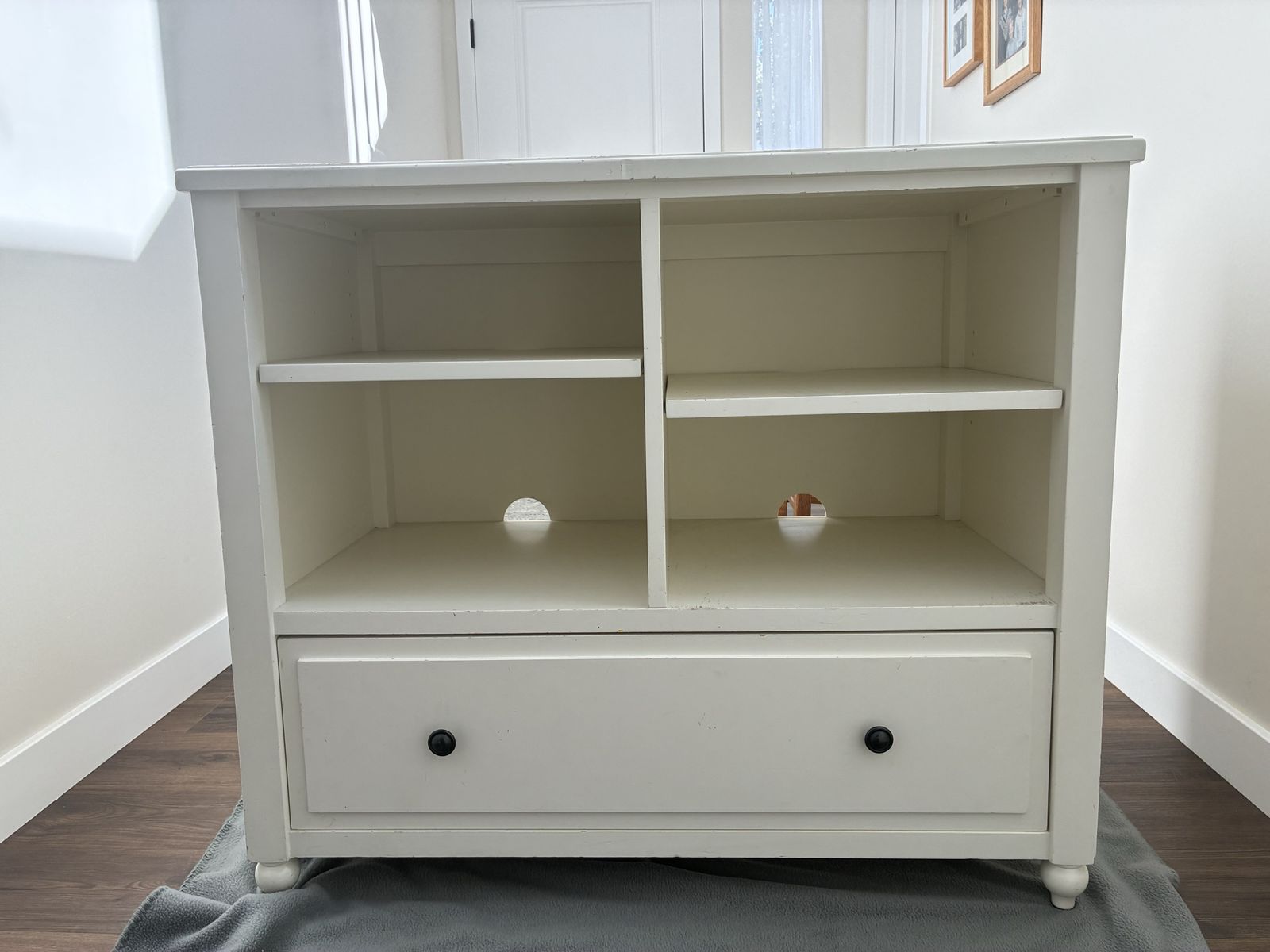 White Sturdy Wooden Changing Table with Open Adjustable Shelves and Bottom Drawer.