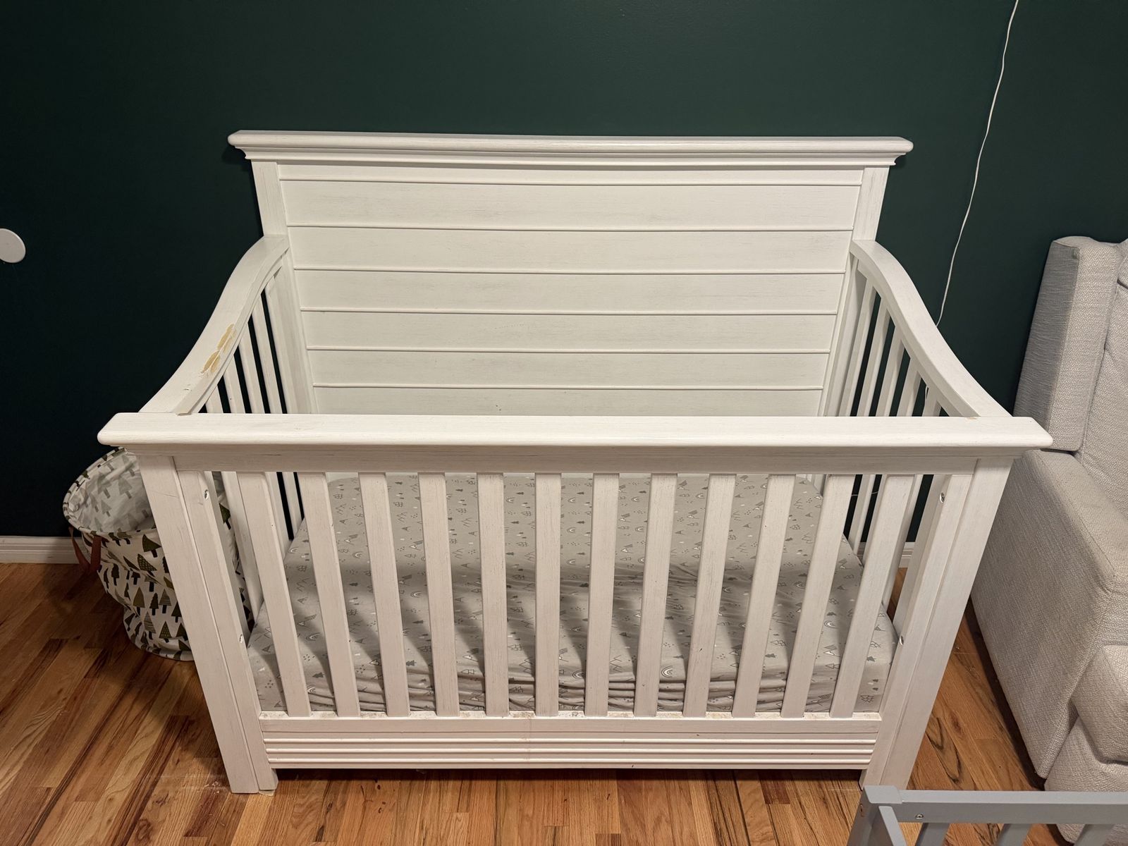 White Wooden Baby Crib with Slat Back Design