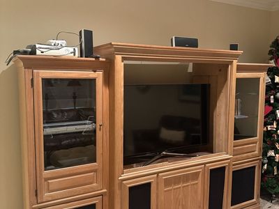 Large Wooden Entertainment Center with Glass Doors and Storage