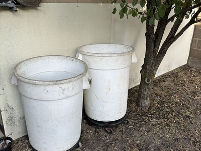 2 White Plastic Garbage Cans with Rolling Dollies - Good Condition, Handles