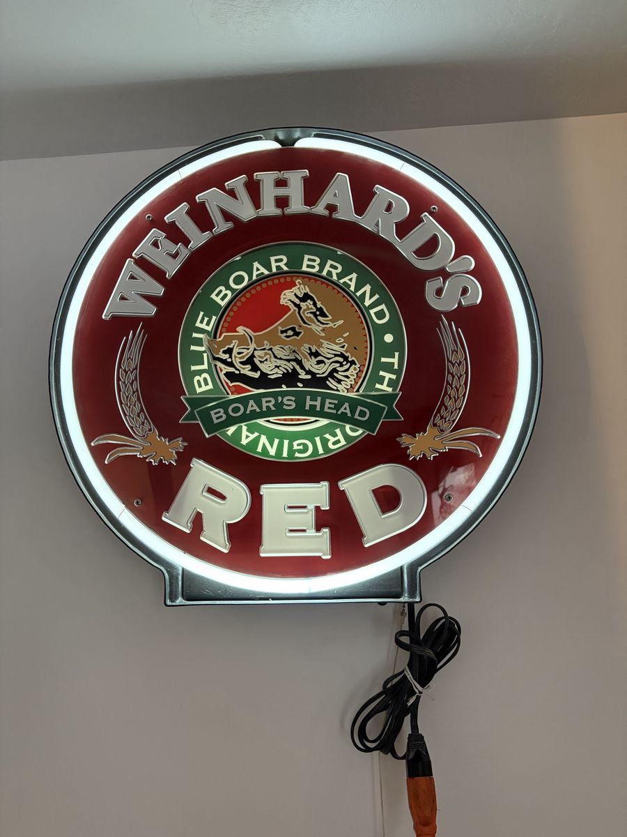 Vintage red glass neon sign. Motorized rotating center wheel