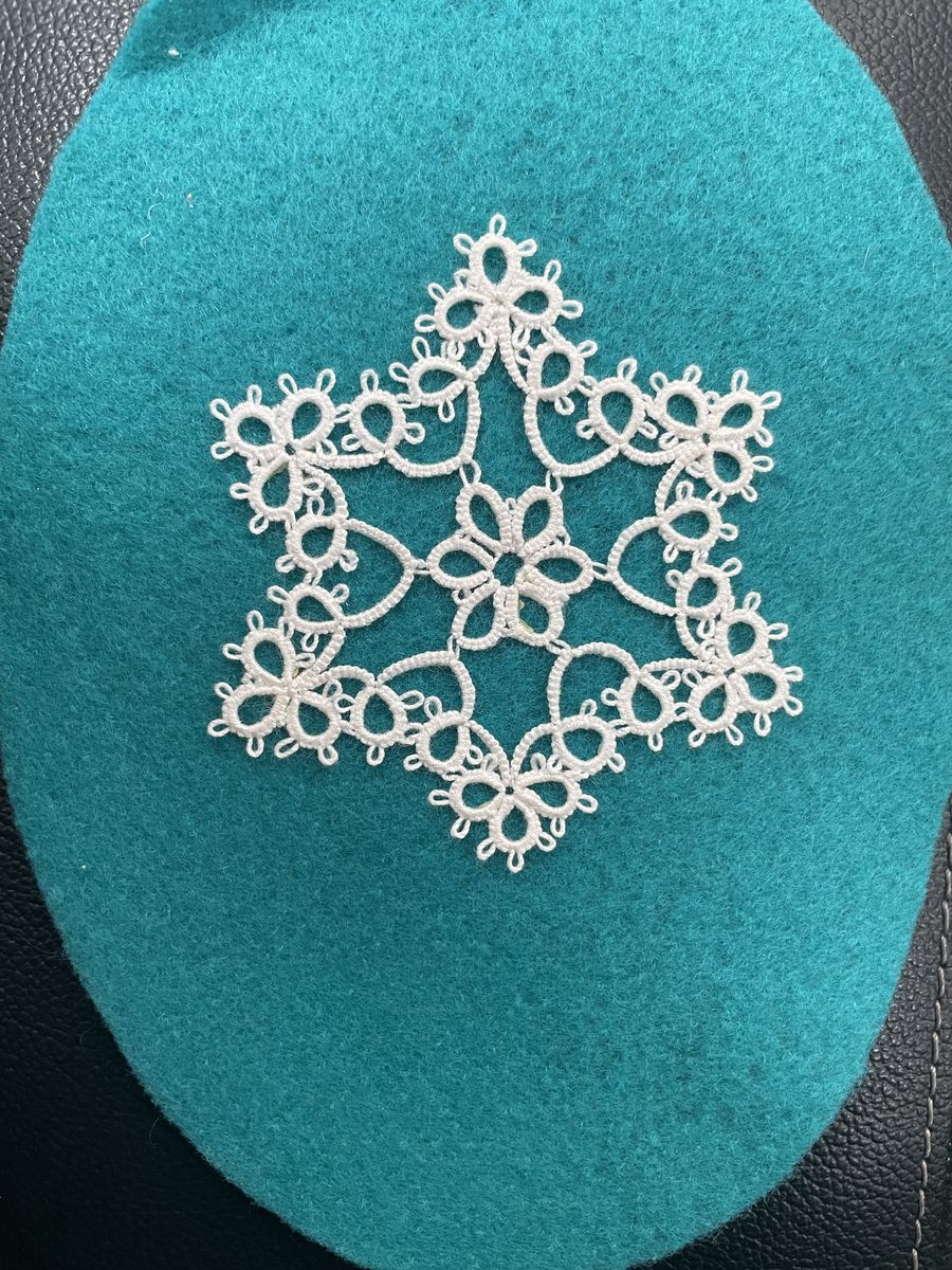 Tatted snowflake on teal felt