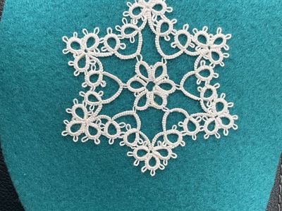 Tatted snowflake on teal felt