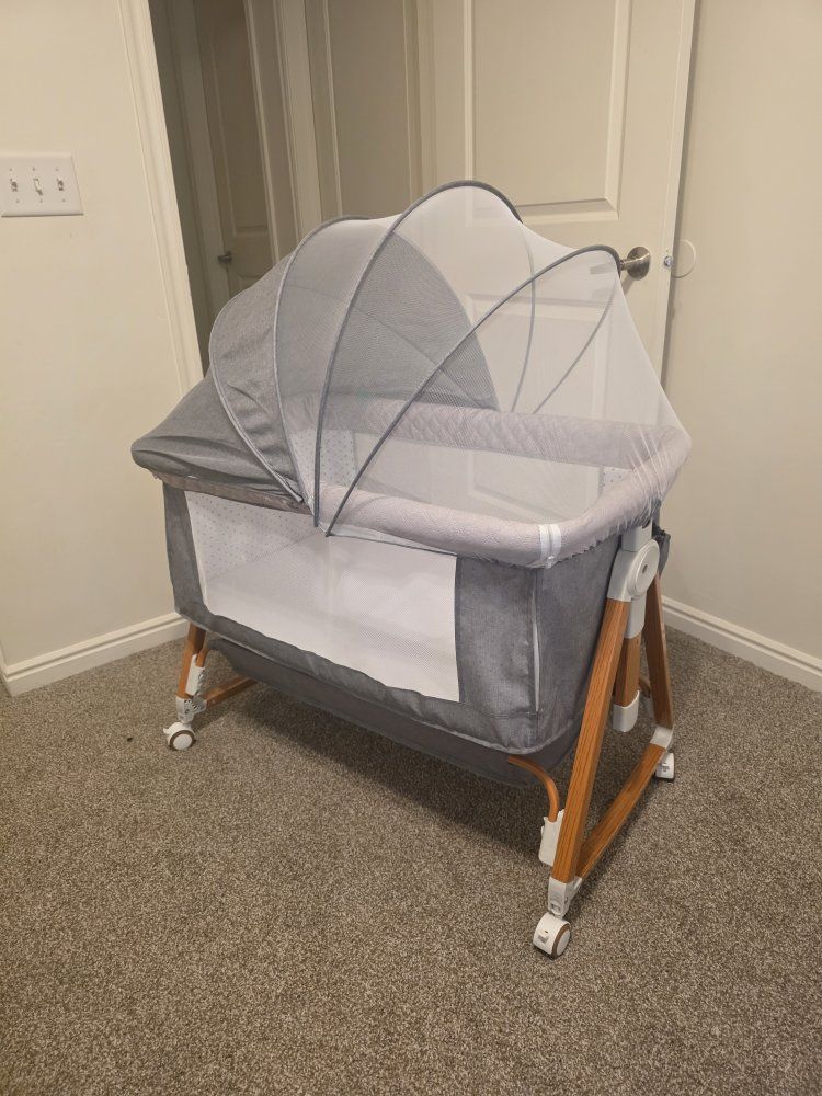 Gray, Mesh Netting, Adjustable Height bassinet.