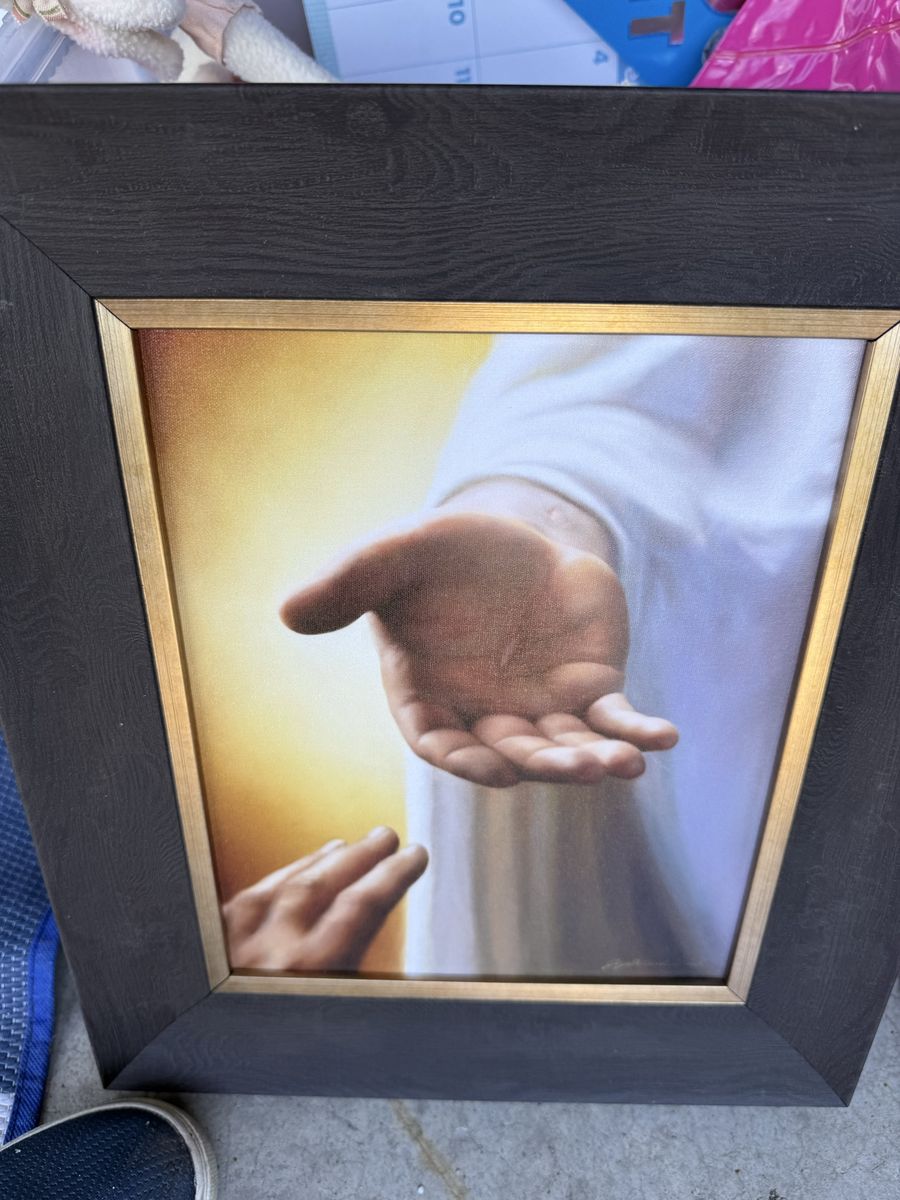 The hand of Jesus in a wood frame