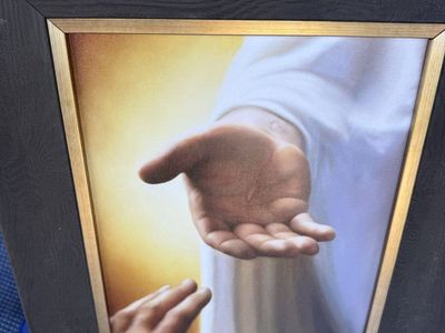 The hand of Jesus in a wood frame