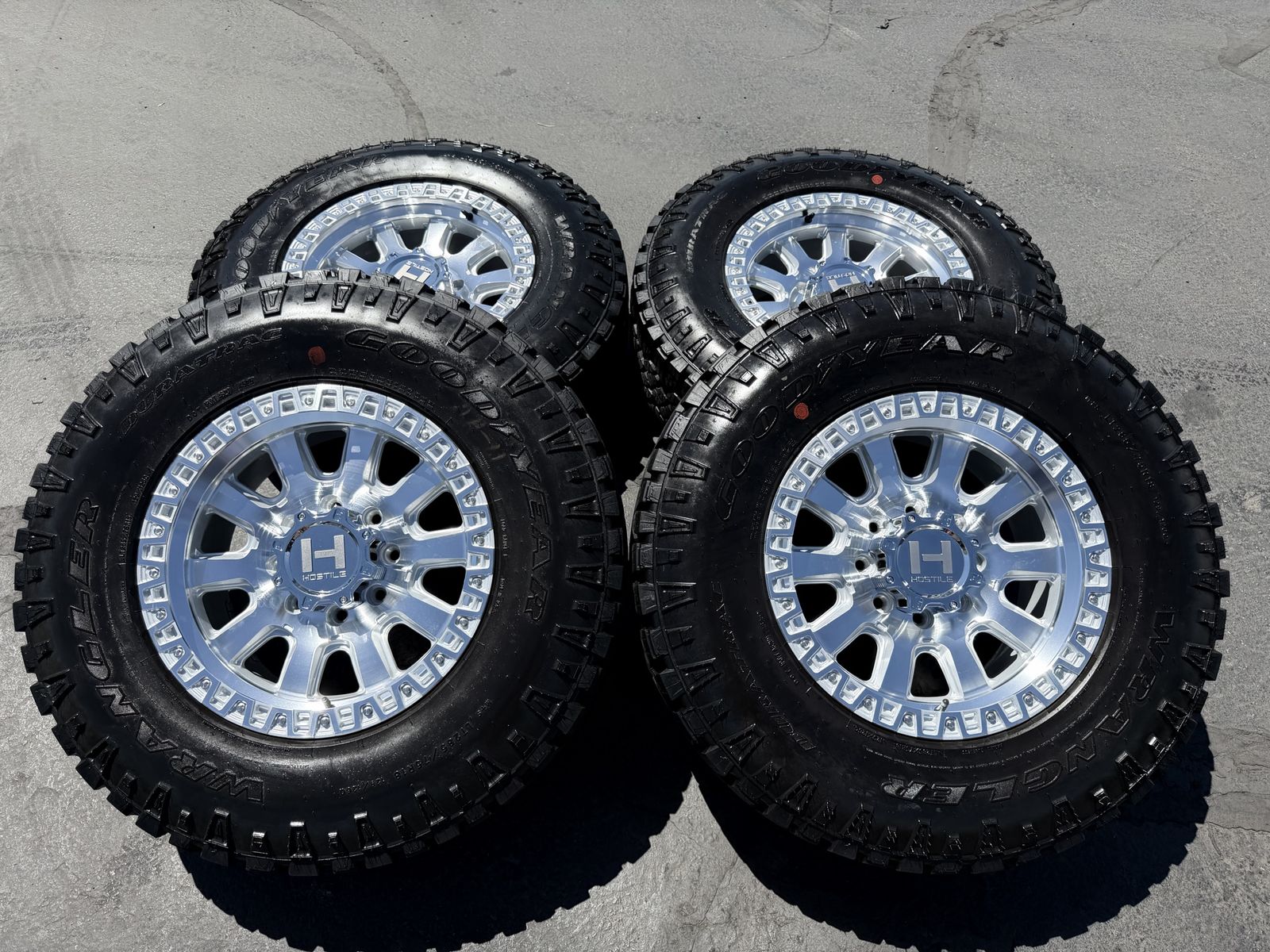 New Silver Hostile H138 LT285/75r18 Goodyears Duratrac 8x6.5 Dodge Ram Cummins Chevy Silverado 2500 3500 8 lug wheels and tires
