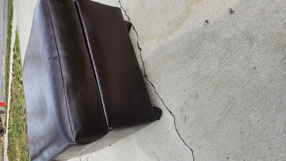 Brown leather ottoman with wheels