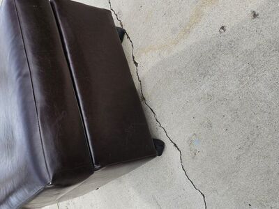 Brown leather ottoman with wheels