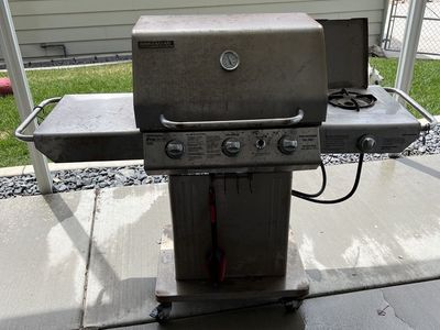 BBQ BrinkMann Pro Series 4040 with side burner, propane tank and the worn cover. Everything working.