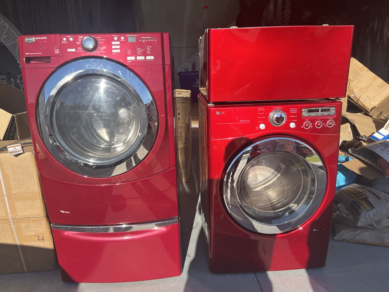 Maytag washing machine and LG electric dryer with pedestals.