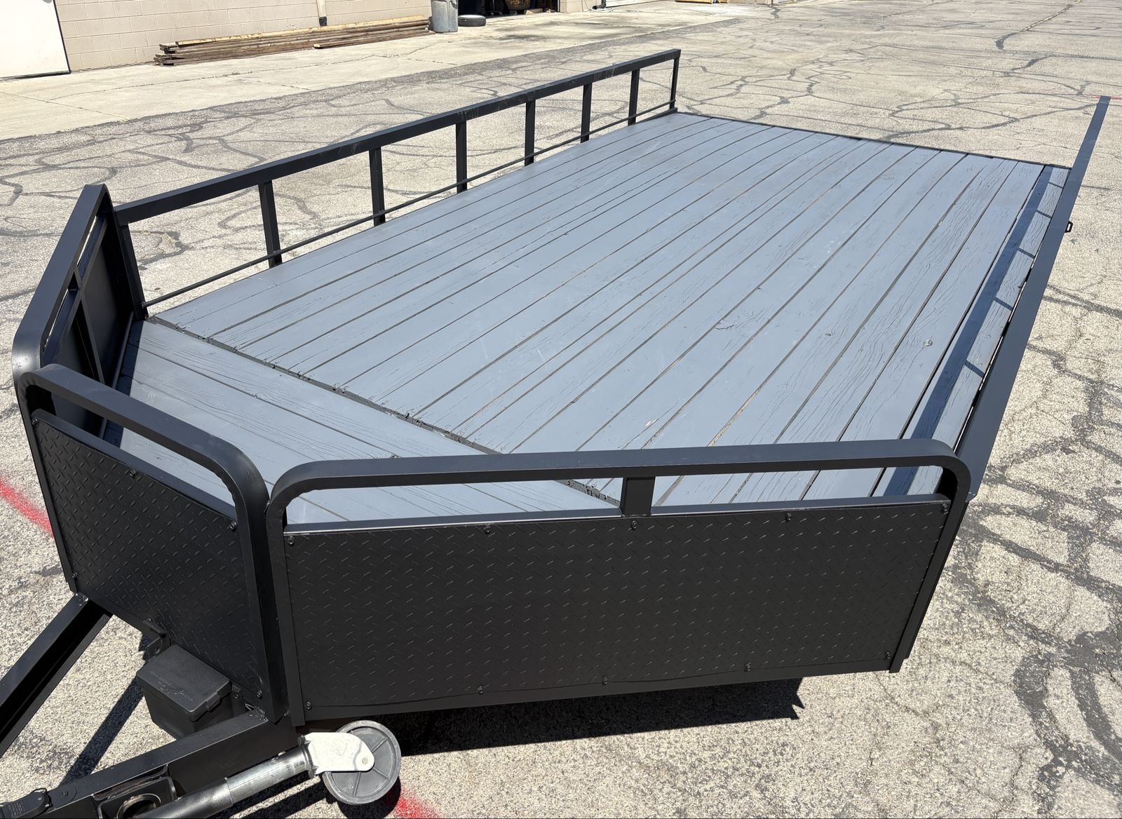 8’ x 14’ + 2’V nose Flatbed Trailer, side rails, fold-down rear rail, ramp stowed under deck.