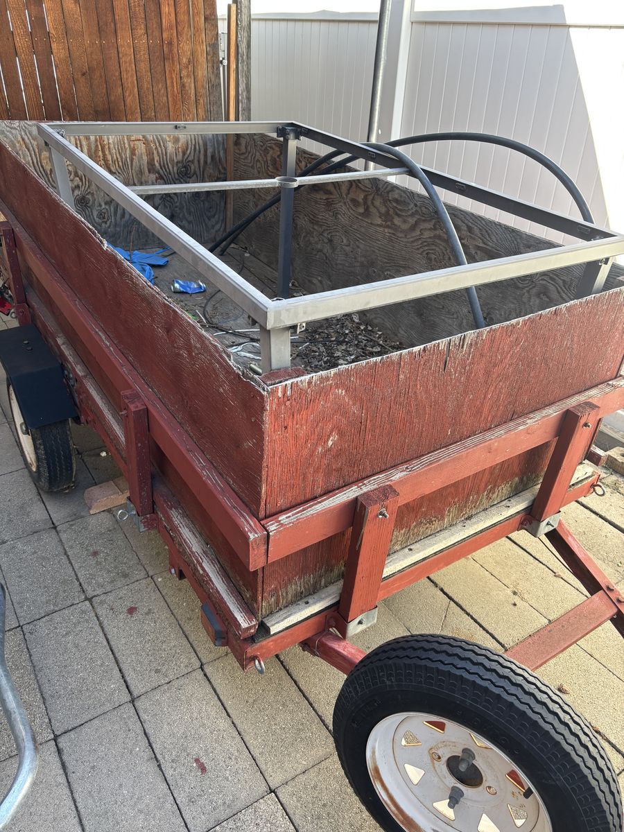 Red Wooden Utility Trailer with Wheels and Metal Frame