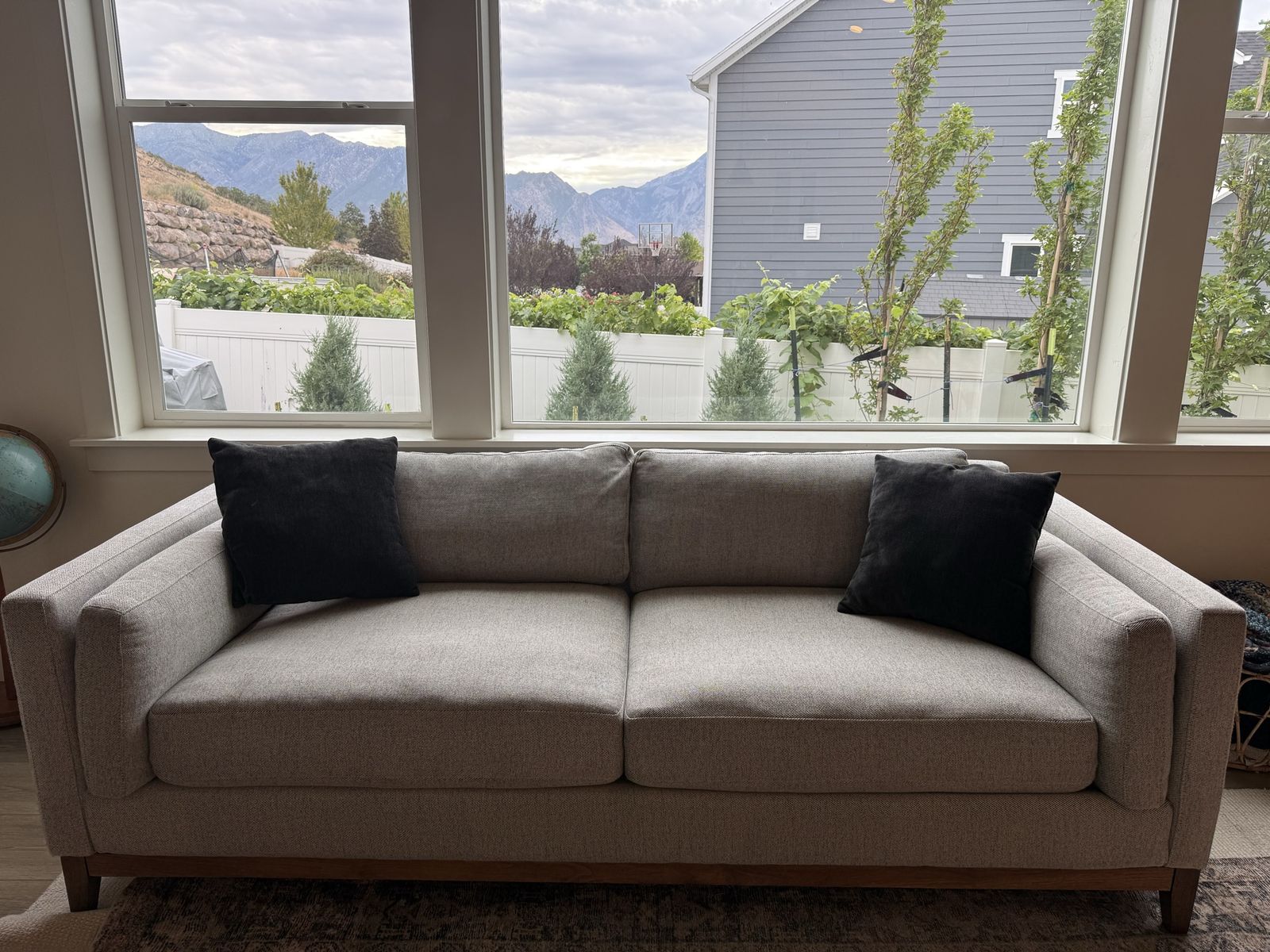 Light Gray Fabric Sofa with Wooden Base Frame and Accent Pillows