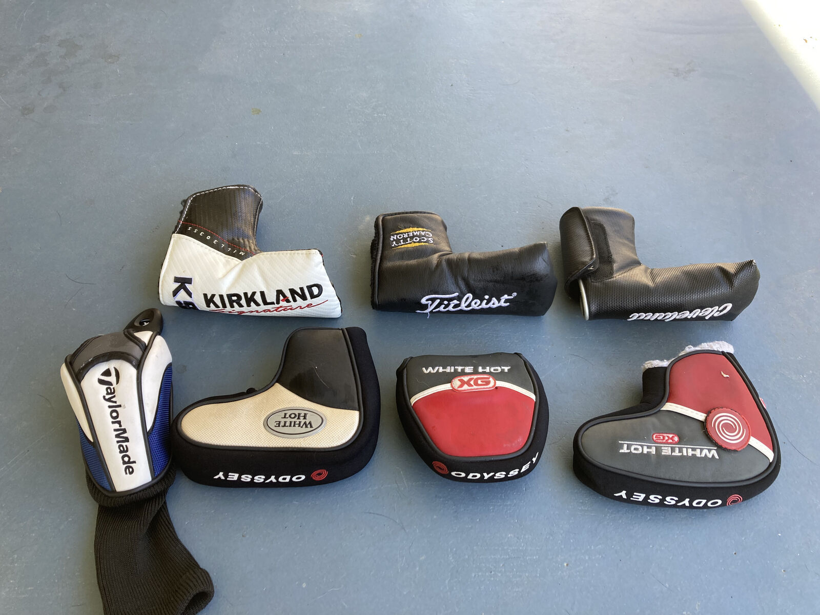 Various golf club covers for putters and hybrid clubs including Scotty Cameron, Odyssey and Cleveland
